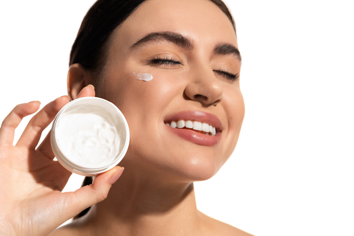 close-up-of-smiling-woman-applying-cream-to-face-2026-03-25-09-41-02-utc.jpg
