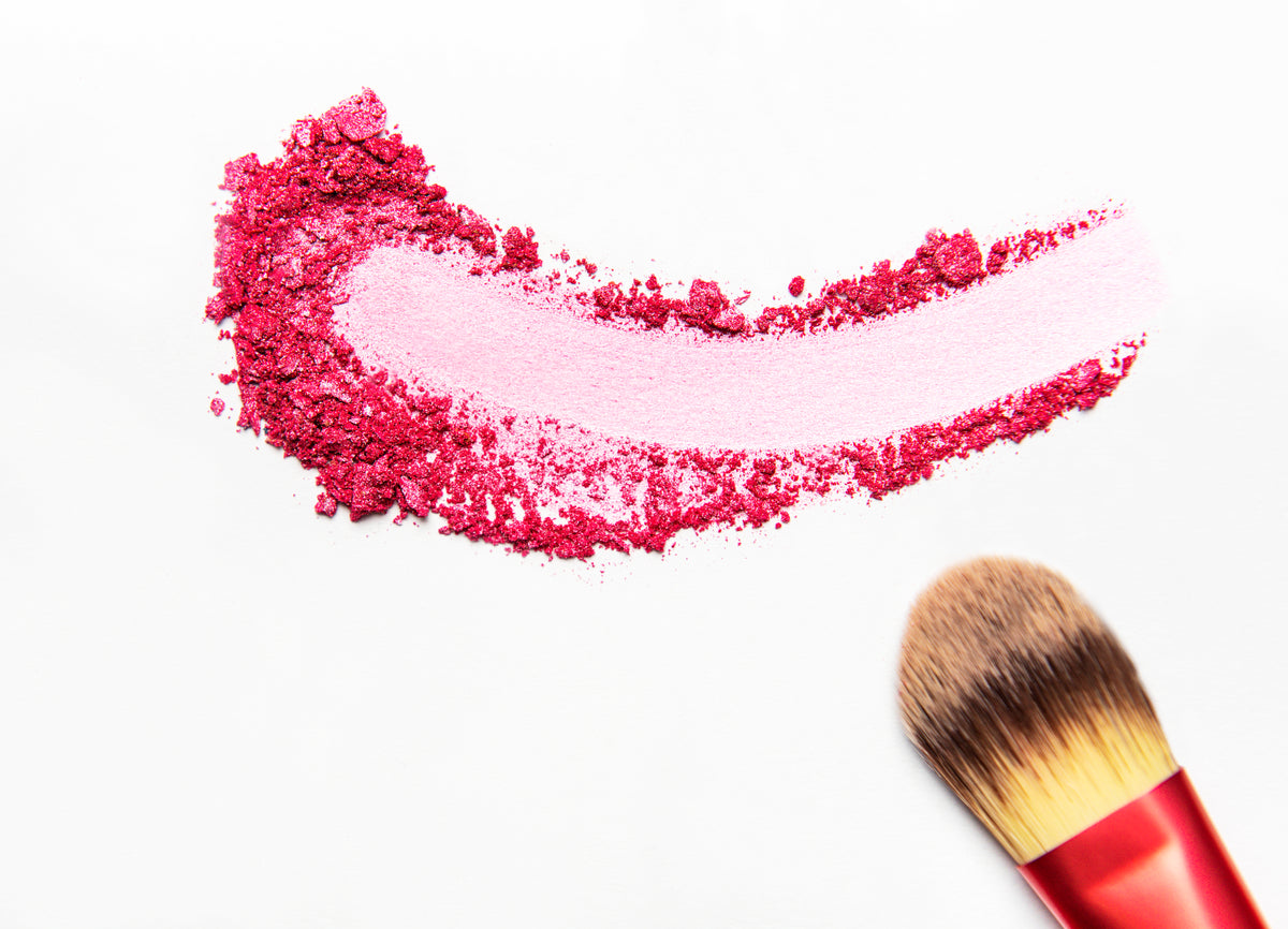 pink-blush-and-makeup-brush-on-white-surface-2026-03-17-05-06-52-utc.jpg